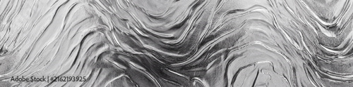 An abstract monochrome texture featuring flowing, wavy ripples and soft, organic light reflections, designed for an artistic background.