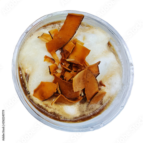 Iced coffee in a glass on an isolated background. Close up. Top view.