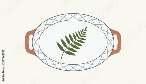 White oval ceramic plate decorated with a green fern leaf illustration and grid pattern border rests on a cream background.