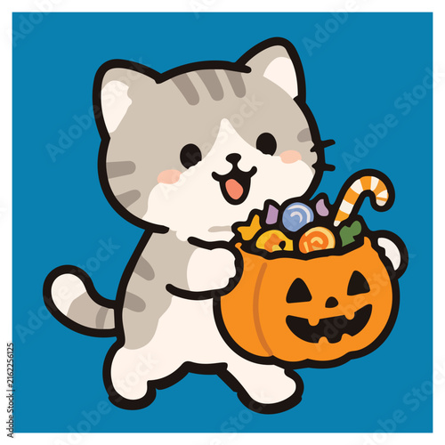 Bild auf Leinwand Cute gray and white cat carrying a pumpkin basket filled with colorful Halloween candy and sweets for trick or treating