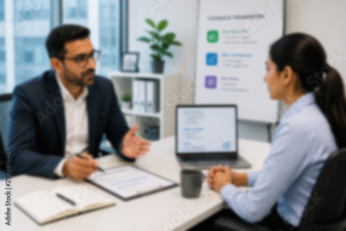 Blurred Manager Giving Constructive Performance Feedback To An Employee During A Professional Office Meeting