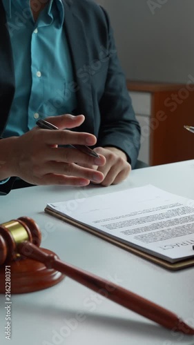 Lawyer advising client and reviewing legal contract