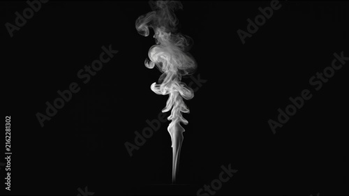 White smoke curling upward isolated against a deep black background
