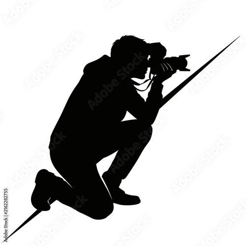 Action Silhouette of a Professional Cameraman Kneeling