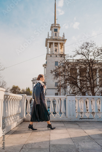 Fotografie Woman architecture walking outdoors along white balustrade with majestic classic