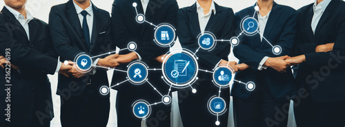 Фотография A professional business team stands together, showcasing collaboration and innovation with digital connections, symbolizing teamwork and modern solutions in the workplace