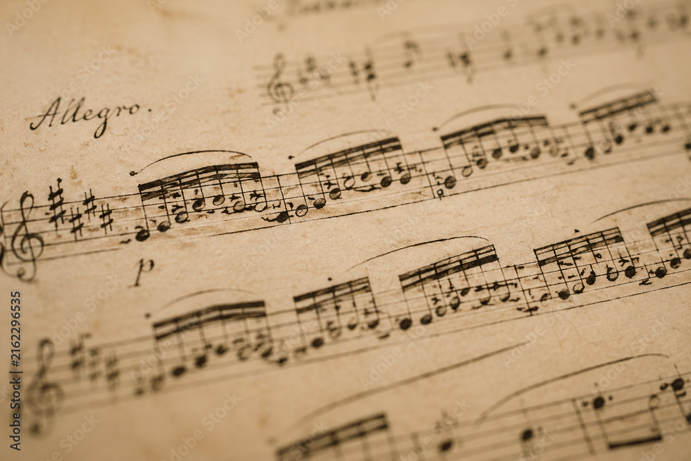 Fototapeta premium Classical music manuscript with flowing notes on aged paper.