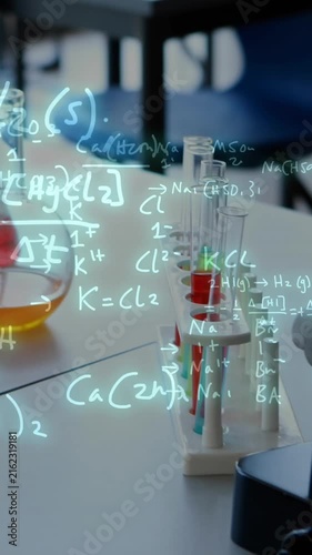 Animation of mathematical equations over colourful vials in lab