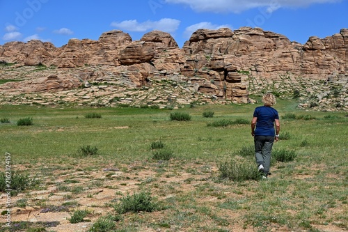 Rear view of senior woman hiking in the rocky landscape, Mongolia