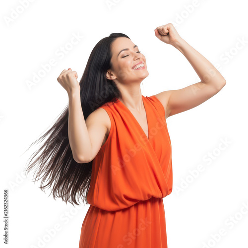 Confident woman celebrating triumph with fists raised