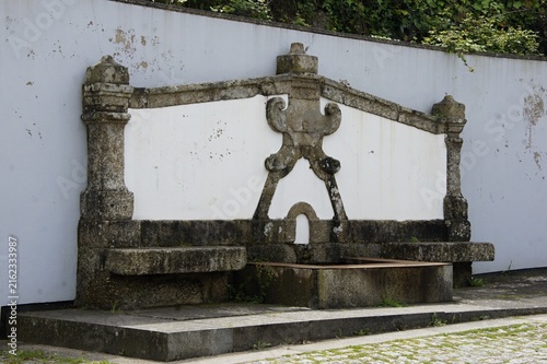 Ornate stone fountain with decorative elements and basin. Portugal - Norte