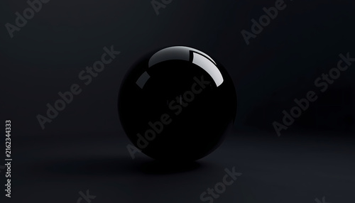 Photography A shiny black sphere sits alone in a dark room with a subtle reflection on its s