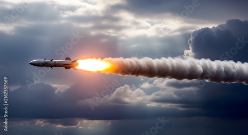 Guided missile flying through cloudy sky at high altitude.