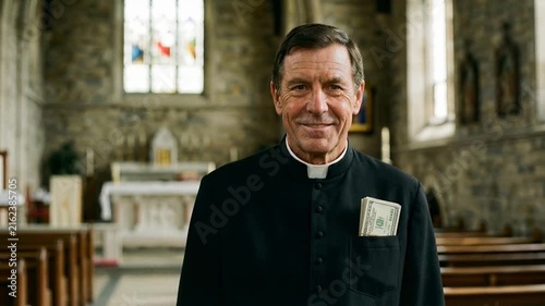 Smiling priest in black cassock with money in pocket inside church
