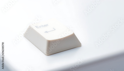 Minimalist Close-up of a White Enter Key on a Computer Keyboard Representing Decision and Success
