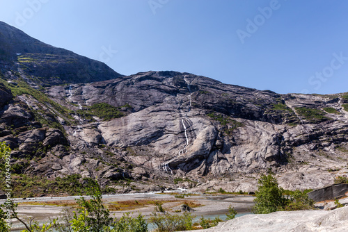 Konstfotografi Rocky gorge slope with numerous waterfalls in Jostedalen valley, Norway
