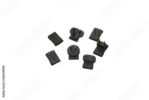 Set of interchangeable power plug adapters isolated on white backgroun, Universal international travel adapter plugs kit top view