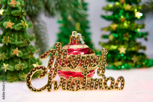 A pine cone with letters among green fir trees