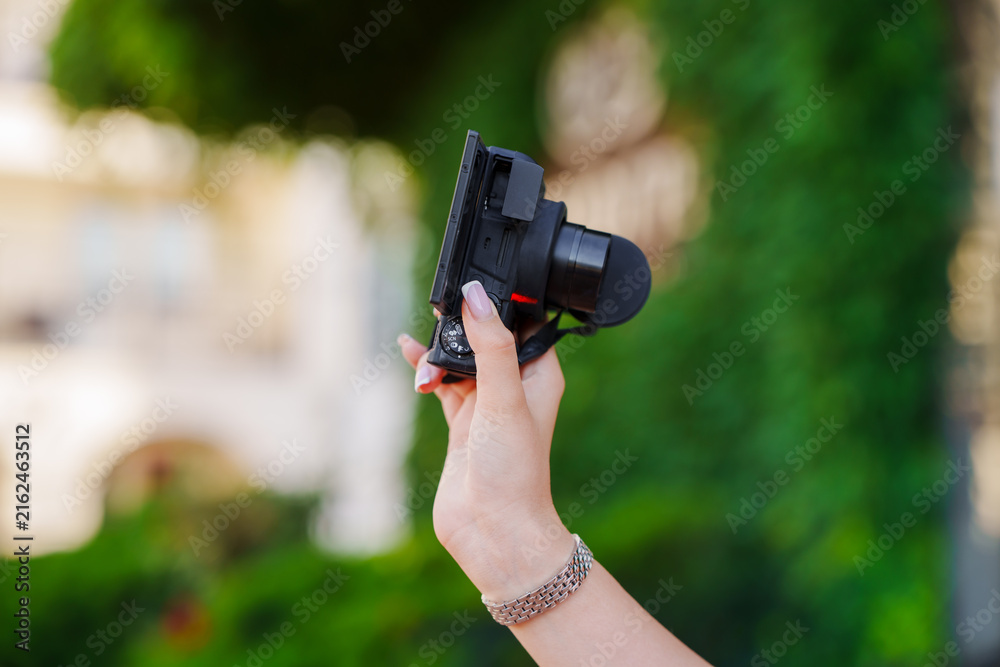 Fototapeta premium Woman Hand Holding Compact Digital Camera Outdoors