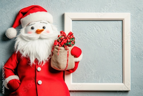 A santa inspired snowman complete with a red coat and gifts for a christmas and xmas holiday event card