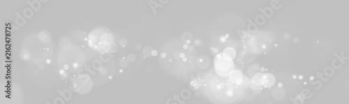 Horizontal trail of soft white glowing bokeh lights with scattered sparkles on transparent background