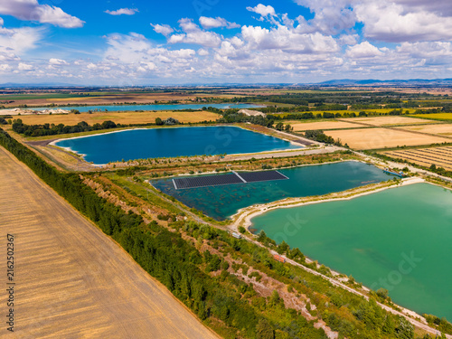 Fotografie Aerial view of water ponds and farmland during a sunny day