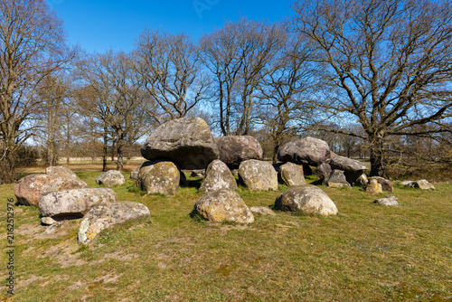 Fotografie The mystical dolmen D15 surrounded by oak trees on a winter's day at Loon, Drent