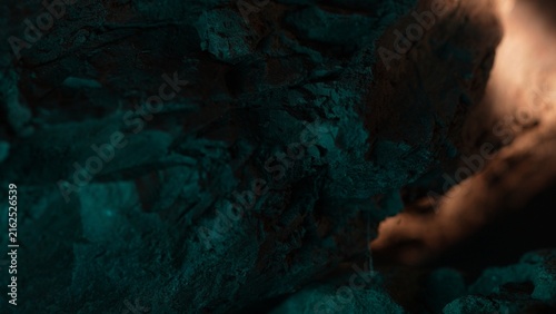 Rock wall with teal shadow and warm light abstract background texture