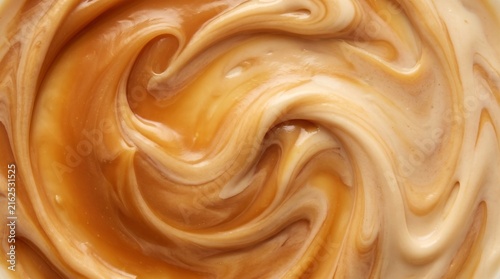 Close-up swirls of golden caramel sauce drizzled in creamy texture for food styling