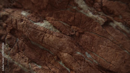 Weathered red stone texture in slow macro tracking shot