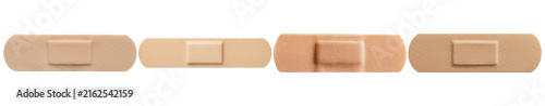 Fotografie Set of four assorted adhesive bandages (band-aids) in various skin tones, isolated on a transparent background
