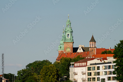 Obraz na płótnie Vertical telephoto architectural photo of Wawel tower above rooftops in Krakow,