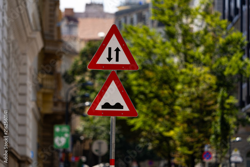 Fotografie Traffic sign warns drivers about opposing traffic and uneven roadway conditions