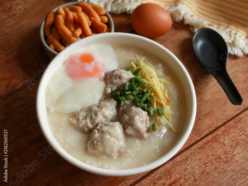 Congee or rice porridge top with minced pork, ginger and green onion. Popular breakfast bowl in China, Thailand, and Asia.