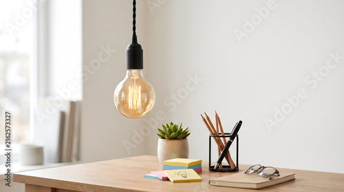 Lightbulb, Creative, A brightly lit vintage-style light bulb hanging over a modern desk with pencils, sticky notes, and a succulent plant