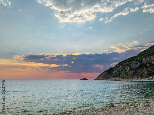 Bild auf Leinwand Scenic sunset over Adriatic sea coast with crepuscular sun rays breaking through