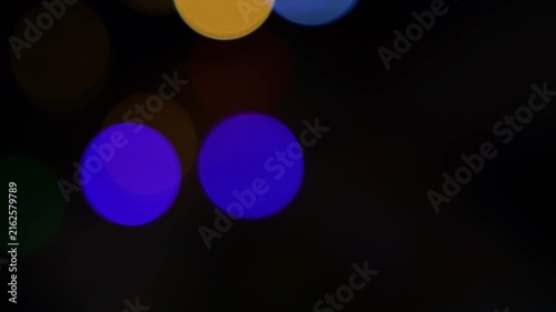 Abstract blurred blue and green bokeh lights on a dark background, creating a soft glowing night scene