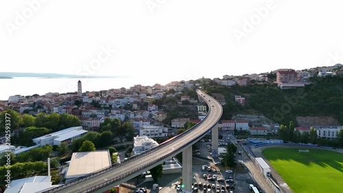 Bridge curves uphill.
Highway reaches hillside.
City surrounds viaduct.
Water meets horizon.