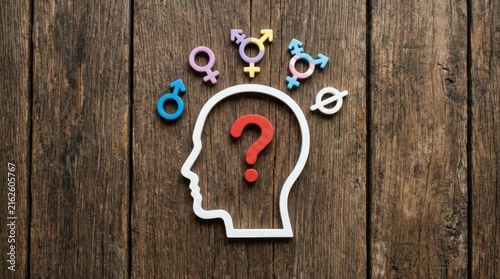 Gender identity concept with question mark in human head silhouette on wood background