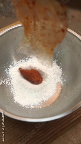 Cooking Thai crispy small shrimp patties by mixing freshwater shrimp with red curry paste, batter, and fresh basil, then deep-frying in hot oil until golden brown.