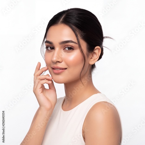 Beautiful Indian Woman Touching Glowing Face Skincare and Natural Beauty Portrait