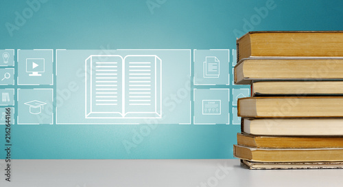 Fotografie E learning tools and resources with stacked books and digital icons on a blue ba