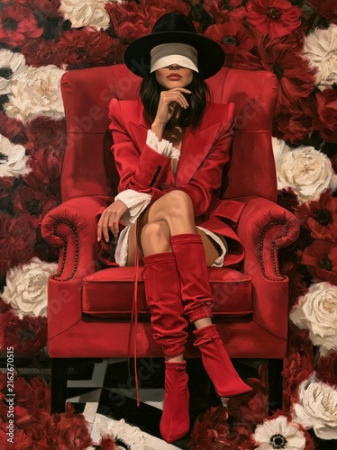 A young woman sits in an English armchair against a backdrop of flowers, her eyes hidden by a blindfold 