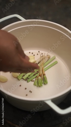 Cooking Thai braised chicken drumsticks in soy sauce (Nong Gai Tom Si Ew) with lemongrass, garlic, and peppercorns, served with spicy seafood dip.