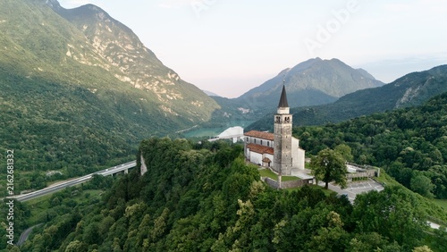 Quadro su tela Aerial view of an ancient stone church on a misty hill surrounded by forest, Ces
