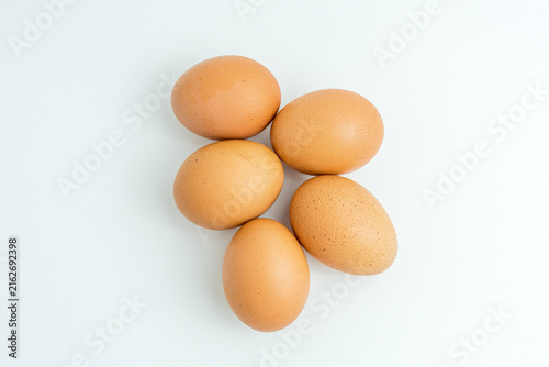 Five raw brown chicken eggs isolated on a pure white background
