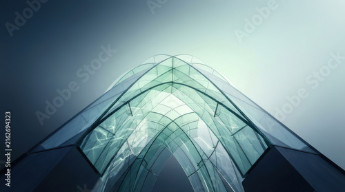 Looking up at a modern glass architectural canopy with curved design