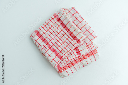 Foto Folded red and white checkered kitchen cloth napkin isolated on a white backgrou