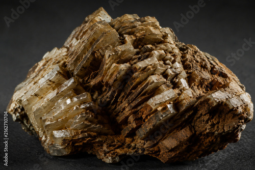 Macro view of broken barite ore showing its tabular crystal structure and earthy texture.