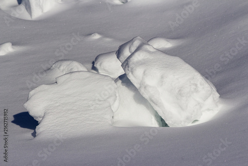 Quadro su tela Close-up of chunky snow blocks piled in a frozen winter landscape, highlighting
